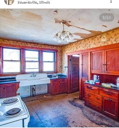 an old kitchen with wooden cabinets and white appliances in it's center island area