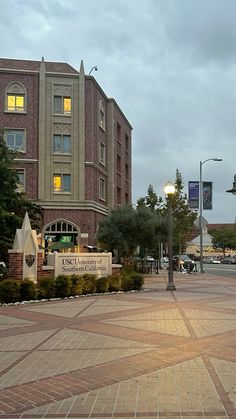 an empty square in front of a brick building