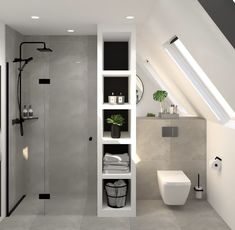 a bathroom with a white toilet sitting next to a walk in shower under a slanted skylight