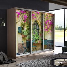 an open sliding glass door with flowers on it