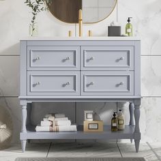 a bathroom vanity with drawers and towels on it