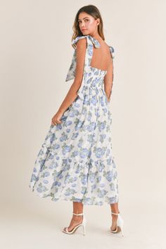 Elegant, trendy, and chic, our Florence Blue Floral Tie Strap Midi Dress is perfect for wedding guests, special events, showers, and vacations abroad. Featuring a ruched bodice, tie straps, tiered skirt, padded inserts, a smocked back, back zipper closure, and a blue floral print pattern throughout. Lined. 100% Polyester. True to size. Model measurements: Height 5'5", Bust 33", Waist 25", Hips 33" wearing a size Small. Cindy Dress, Flower Maxi Dress, Floral Bustier, Bra Cup, Tiered Midi Dress, Flowing Skirt, Dresses By Length, Crop Top Sweater, Dress With Tie