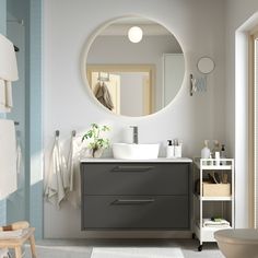 a bathroom with a sink, mirror and towel rack on the wall in front of it