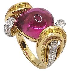 Cabochon Pink Tourmaline 11.94 carats with Diamond 0.69 carat and Yellow Sapphire 5.29 carats Ring set in 18 Karat Gold Settings Width: 2.3 cm Length: 1.5 cm Ring Size: 54 Total Weight: 12.1 grams "We first opened doors in 1980 when it was then situated in the vicinity of the Victory Monument; a small and modest storefront with a couple of counters. From its humble beginnings to where it stands today, our company has proven its abilities as a jeweler. Since the beginning, we have been supplying Stunning Aesthetic, Ruby Jewel, Yellow Sapphire Rings, Contemporary Ring, Pink Ring, Yellow Sapphire, Pretty Jewellery, High Jewelry, Pink Tourmaline