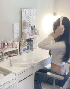 a woman sitting at a desk with her back to the camera