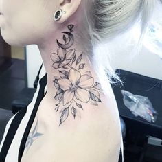 a woman with a flower tattoo on her neck