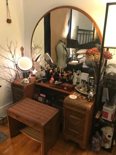 a mirror sitting on top of a dresser next to a wooden table with a stool