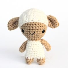 a small crocheted sheep with a white hat on it's head and legs