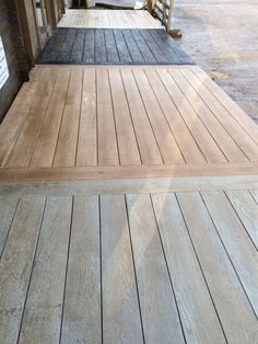 two wooden benches sitting next to each other on a porch