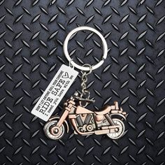 a metal keychain with a motorcycle on it