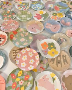 many plates with animals and flowers on them