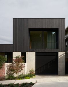 a black and white house with two garages