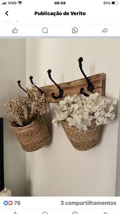 two baskets filled with flowers hanging on a wall