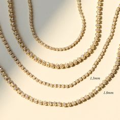 A shining tennis necklace, made of 100% recycled 14k gold and recycled brilliant cut diamonds. Now available in two carat weights — our classic slim bracelet, and a new larger, starrier size. Our strong, discreet clasp is cleverly and luxuriously set with diamonds. Equally suited to be worn at midday, and past midnight. This is the one you’ve been waiting for. 14k Yellow Gold Tennis Necklace, Timeless Tennis Necklace With Round Cut For Everyday Luxury, Everyday Luxury Diamond White Tennis Necklace, Minimalist Cubic Zirconia Tennis Necklace, Timeless Tennis Necklace With Diamond Accents Gift, Fine Jewelry Round Tennis Necklace For Everyday Luxury, Minimalist Diamond Tennis Necklace For Anniversary, Timeless Brilliant Cut Tennis Necklace Gift, Timeless Brilliant Cut Tennis Necklace As Gift