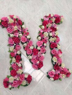 the letter m is made up of pink and white flowers