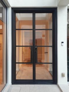 an empty room with glass doors and white walls