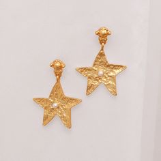 VAIGE Vintage Gold Matte Star Drop Earrings in 925 Silver Elevate your accessory game with the stunning VAIGE Vintage Gold Matte Star Drop Earrings. Crafted with precision from 925 silver, these earrings offer a unique blend of elegance and contemporary style, making them the perfect addition to any outfit. Product Features: Materials: Made from high-quality 925 silver for durability and a luxurious finish. Eye-Catching Design: The vintage gold matte finish coupled with a geometric star shape ad Elegant Star Embellished Earrings As Gift, Elegant Star Embellished Earrings For Gift, Celestial Star-shaped Pierced Earrings, Celestial Star Earrings For Anniversary, Star-shaped Tarnish Resistant Earrings For Gift, Star-shaped Single Earring For Anniversary, Star Shaped Tarnish Resistant Earrings For Gifts, Single Star-shaped Earring For Anniversary, Star-shaped Earrings With Star Charm For Anniversary