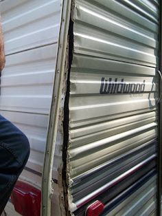 a man standing next to a metal trailer