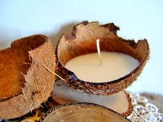 two coconuts are next to a candle on a doily