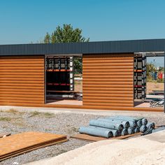 the building is made out of wood and has metal pipes on it's sides