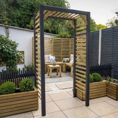 an outdoor garden with wooden planters and trelliss