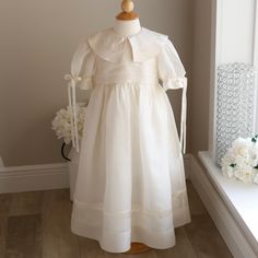 This Rare Strasburg Elegant Heirloom Dress Is Stunning! Made Of A Fine Silk Organdy, The Color Is A Lovely Ecru With Ivory Satin Trim. One Of Strasburg's Most Elegant Designs, This Dress Has Beautiful Detailing. The Hand Embroidered Collar Is Trimmed With A Matching Satin Edge. The Bodice Has Layers Of Soft French Tucks That Wrap All The Way Around The Back Of The Dress (This Feature Is Not Only Incredible, But Extremely Rare. Most Of Strasburg Dresses With French Tucks Only Have Them Across The Ring Bearer Outfits, Heirloom Dresses, Bearer Outfit, Embroidered Collars, Communion Dresses, Dress Silk, Elegant Designs, Ring Bearer, Girl Dresses