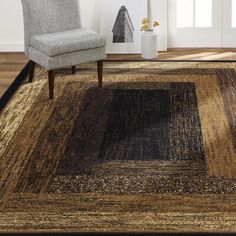 a chair sitting on top of a wooden floor next to a brown and black rug