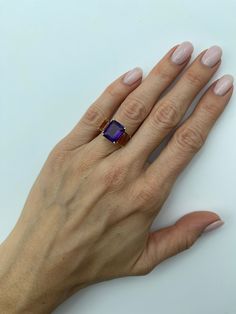 This pretty 3-stone cocktail ring features emerald-cut amethyst paired with intense citrine to show off two beautiful colors of the same gem mineral! The amethyst is a beautiful, royal purple color and the citrine are fine "madeira" variety, aptly named after Madeira wine because of its warm, rich hue. Set in 18k yellow gold, these two gems show why purple and gold are such a classic and ever-popular color combination - even nature thought so!Ring size 6.5Complimentary ring sizing as neededAmethyst, 12.00 x 10.00mm, 5.38 caratsEmerald cut Citrine, 8.00 x 6.00mm, 3.49 carats total Royal Purple Color, Amethyst And Citrine, Gem Show, Popular Color, Royal Purple, Cocktail Ring, Three Stone, Color Combination, Cocktail Rings