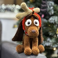 a crocheted dog wearing a reindeer hat