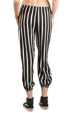 A bold take on an iconic '80s style, these laid-back pants show off contrasting stripes and relaxed balloon legs in a cropped silhouette. 21" inseam; 7 1/2" leg opening; 10 1/2" front rise; 14 1/2" back rise (size S) 100% polyester Dry clean Made in the USA Black Bottoms With Striped Hem For Spring, Relaxed Fit Bottoms With Contrast Stripes For Spring, Black Spring Bottoms With Striped Hem, Trendy Bottoms With Contrast Stripes For Spring, Spring Relaxed Fit Bottoms With Contrast Stripes, Spring Black Bottoms With Striped Hem, Spring Bottoms With Contrast Stripes And Relaxed Fit, Black Pants With Contrast Stripes For Spring, Black Bottoms With Contrast Stripes For Spring