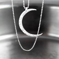 Dainty pendant necklace featuring lightweight shiny .925 Sterling silver hammered crescent moon pendant suspended from sparkly, diamond cut .925 Sterling silver chain. Delicate and subtle by itself, but also makes a great layering necklace.  More details : - High quality USA or Italian made chain and components - ALL .925 Sterling Silver - very sparkly tiny (1mm) diamond-cut bead chain, crescent moon pendant (30x22mm), wire, and trigger clasp. - Choose the length of the necklace from the drop down menu options.  -- More CELESTIAL jewelry, in my shop: https://www.etsy.com/shop/DorotaJewelry?ref=seller-platform-mcnav&search_query=celestial --- All of the designs in my shop are handmade by me in my Virginia studio. Elegant GIFT BOX is included with your order YOU CAN ENTER MY SHOP HERE: http: Pjo Oc, Sterling Silver Layered Necklace, Crescent Moon Necklace Silver, Dainty Pendant Necklace, Crescent Moon Pendant, Dainty Pendant, Crescent Moon Necklace, Celestial Jewelry, Bead Chain