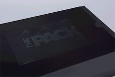 a black box with the words the pack printed on it