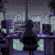 a person sitting at a computer desk in front of a window with cityscape