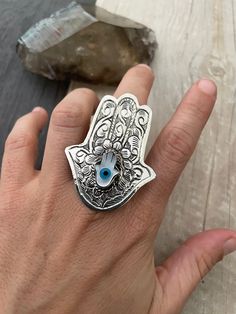 ------Price per item---- Big powerful Hamsa hand evil eye ring. A statement piece that you can rock with your everyday outfit. Made out of alloy metal and a Mother of Pearl hamsa hand or a evil eye. You can choose between those 2 styles. Please see the pictures for the ring's dimensions. A most have addition to your ring collection. ⚡️GET 20% OFF NOW⚡️ JOIN AKASHI'S VIP LIST and Shop ⚡️Join Akashi's VIP list for early bird discount access⚡️ Paste into your browser http://eepurl.com/hgCMM1 and fo Spiritual Evil Eye Ring Jewelry, Symbolic Evil Eye Jewelry Ring, Symbolic Evil Eye Ring Jewelry, Spiritual Evil Eye Rings As Gift, Unique Silver Evil Eye Jewelry, Hamsa Ring, Rings Chunky, Hand Evil Eye, Evil Eye Hamsa