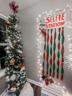 a christmas tree in front of a sign that says selte station on it