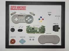 a nintendo wii game controller and parts displayed in a black frame