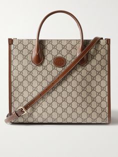 Gucci's tote bag combines the hallmarks of the 'Ophidia' collection from 2018 with the iconic 'GG Supreme' monogram from the 1930s. Made in Italy from durable coated-canvas and brown leather, it's built to hold its structured shape, fully lined in canvas and has the option of a shoulder strap or top handles. Elegant Monogram Canvas Rectangular Bag, Elegant Rectangular Monogram Canvas Bag, Brown Timeless Monogram Canvas Bag, Timeless Brown Monogram Canvas Bag, Classic Gucci Rectangular Bag, High-end Gucci Bags With Leather Handles, Vintage Shoulder Bag For Everyday Luxury, Elegant Everyday Luxury Bag In Coated Canvas, Timeless Monogram Canvas Bag For Formal Occasions