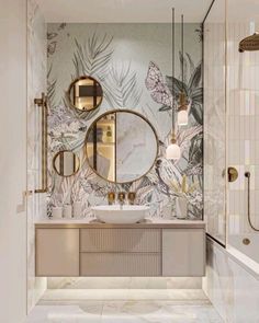 a bathroom with marble counter tops and wallpapered walls, along with an oval mirror above the sink