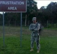 a soldier standing in front of a sign that says frustration area