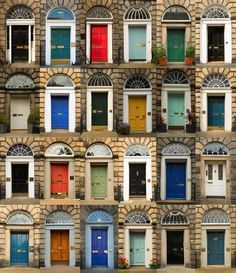 many different doors and windows on the side of an old brick building stock photo image