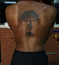 a woman with a tree tattoo on her back