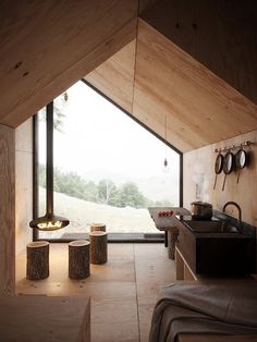 the interior of a small cabin with wooden walls