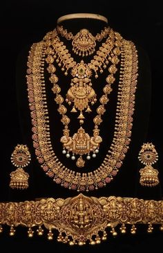 an elaborate gold necklace and earring set