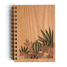 a wooden notebook with an image of plants on it