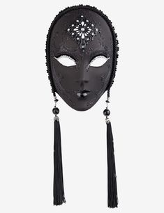 a black mask with long tassels and beads on the side, hanging from it's face