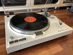 an old record player sitting on top of a wooden floor