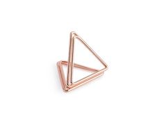 a rose gold triangle ring on a white background