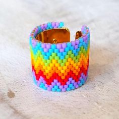 a multicolored bracelet is sitting on the floor