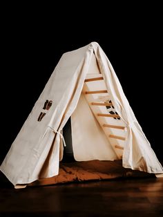 a teepee tent sitting on top of a wooden floor