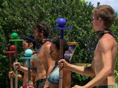 a group of people standing next to each other in front of a pool with toys